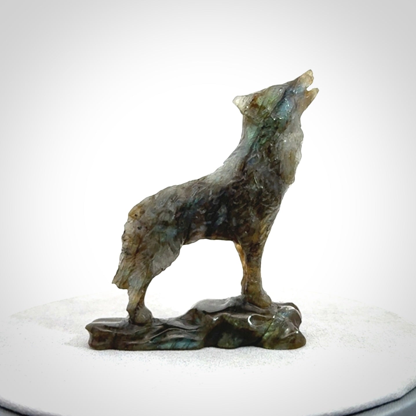 This is a hand carved wolf sculpture made from Labradorite stone.