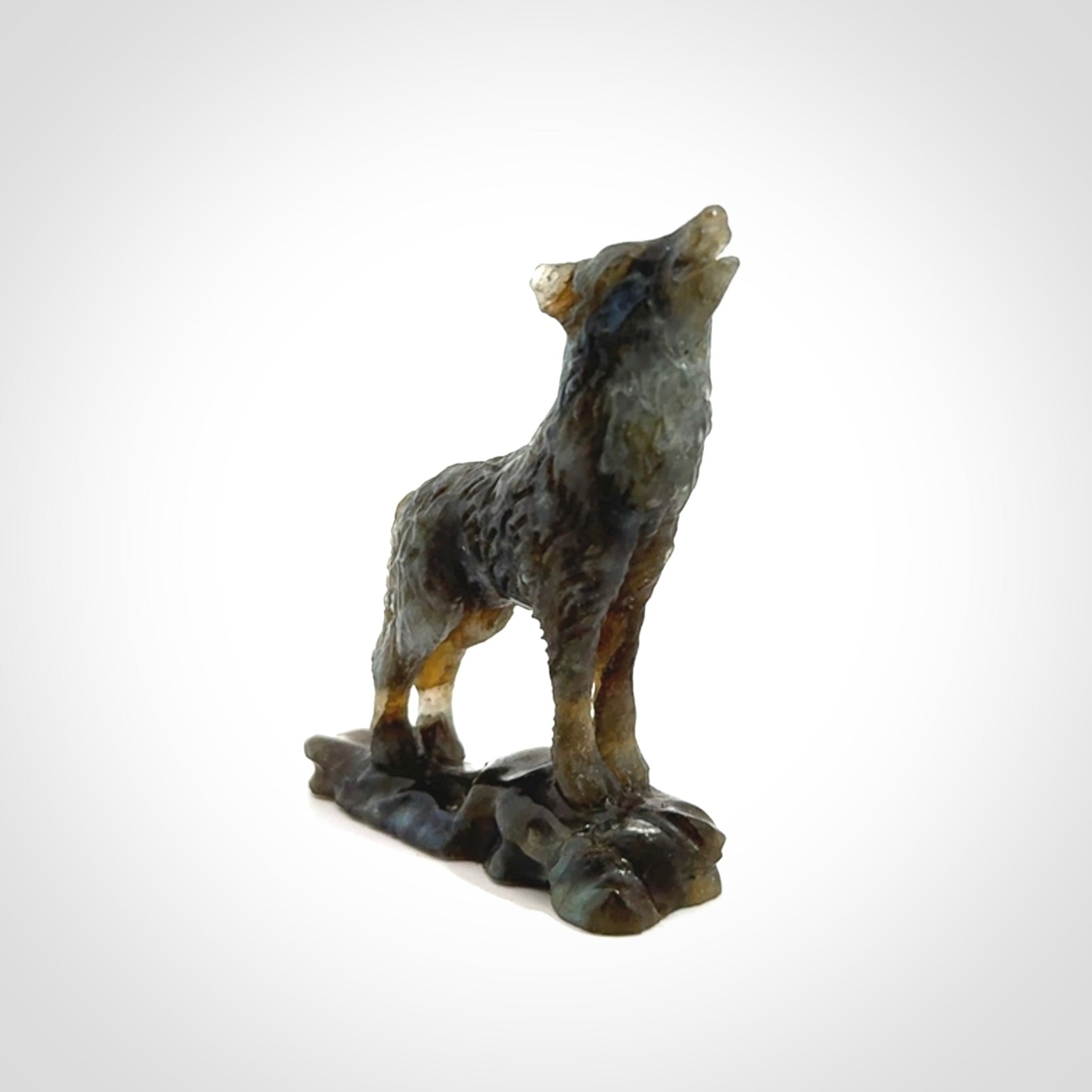 This is a hand carved wolf sculpture made from Labradorite stone.