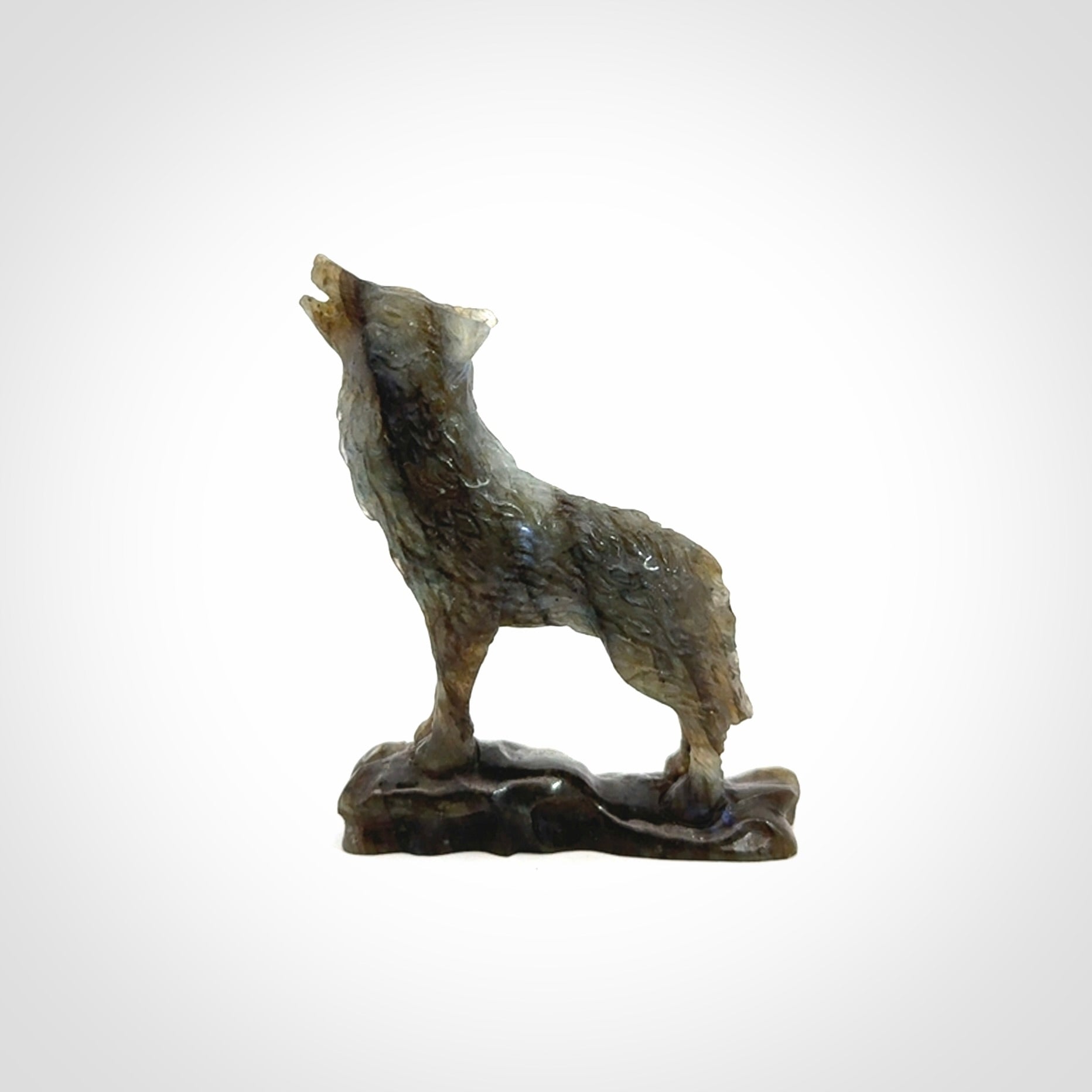 This is a hand carved wolf sculpture made from Labradorite stone.
