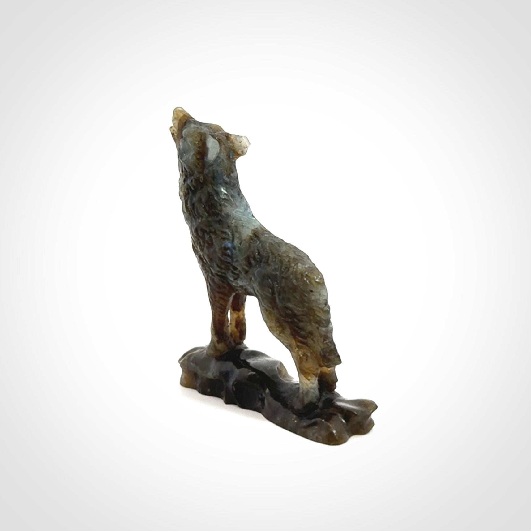 This is a hand carved wolf sculpture made from Labradorite stone.