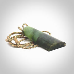 This photo shows a medium sized jade drop shaped pendant. It a a lovely, colourful douglas creek jade. The cord is a tan/green and is adjustable in length. One only large, contemporary drop necklace from Jade, by Rueben Tipene.