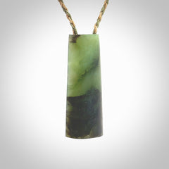 This photo shows a medium sized jade drop shaped pendant. It a a lovely, colourful douglas creek jade. The cord is a tan/green and is adjustable in length. One only large, contemporary drop necklace from Jade, by Rueben Tipene.