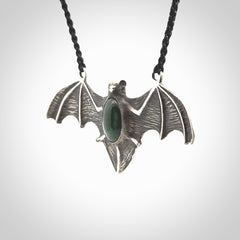 This is a hand carved bat pendant. It is made from New Zealand Jade and Sterling Silver. This is a medium sized necklace and is a very unique, one only, pendant that is a collectors piece. Provided with black adjustable cord.