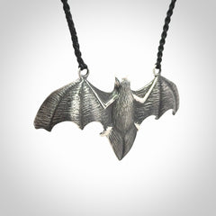 This is a hand carved bat pendant. It is made from New Zealand Jade and Sterling Silver. This is a medium sized necklace and is a very unique, one only, pendant that is a collectors piece. Provided with black adjustable cord.