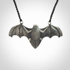 This is a hand carved bat pendant. It is made from New Zealand Jade and Sterling Silver. This is a medium sized necklace and is a very unique, one only, pendant that is a collectors piece. Provided with black adjustable cord.