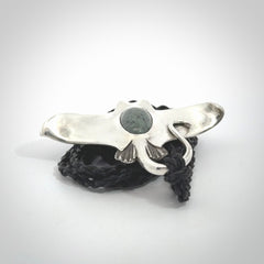 This is a hand carved Sterling Silver Eagle Ray pendant with New Zealand Jade insert. This is a medium sized necklace and is provided with an adjustable black cord.