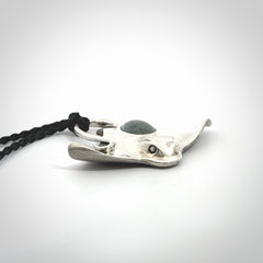 This is a hand carved Sterling Silver Eagle Ray pendant with New Zealand Jade insert. This is a medium sized necklace and is provided with an adjustable black cord.