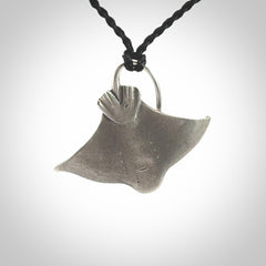 This is a hand carved Sterling Silver Eagle Ray pendant with New Zealand Jade insert. This is a medium sized necklace and is provided with an adjustable black cord.