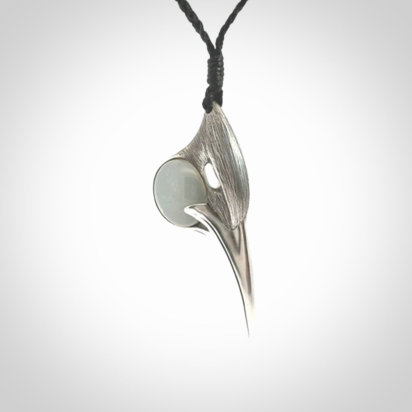 This is a hand carved Sterling Silver Huia bird pendant with Siberian Jade insert. This is a medium sized necklace and is provided with an adjustable black cord.