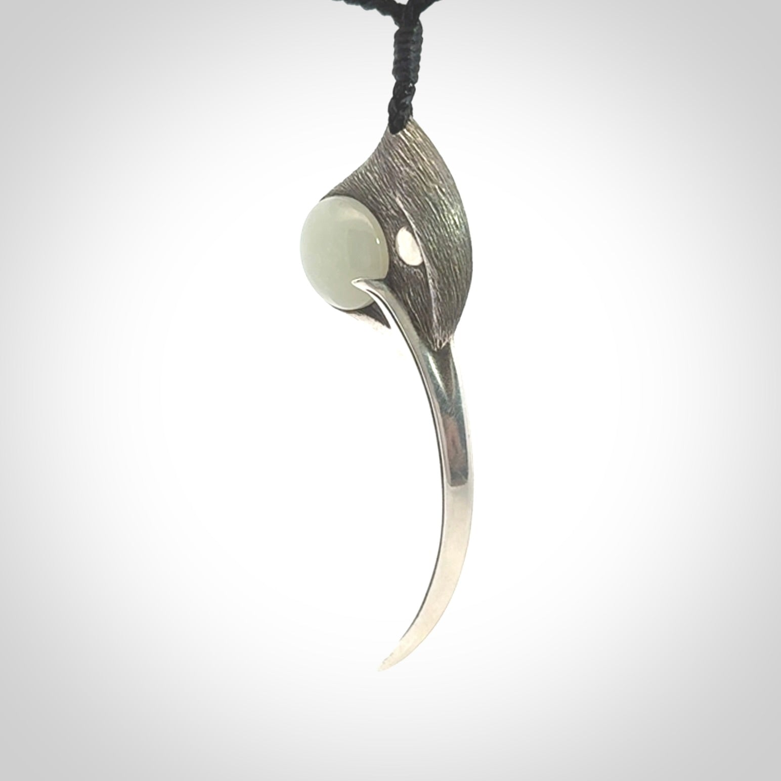 This is a hand carved Sterling Silver Huia bird pendant with Siberian Jade insert. This is a large sized necklace and is provided with an adjustable black cord.