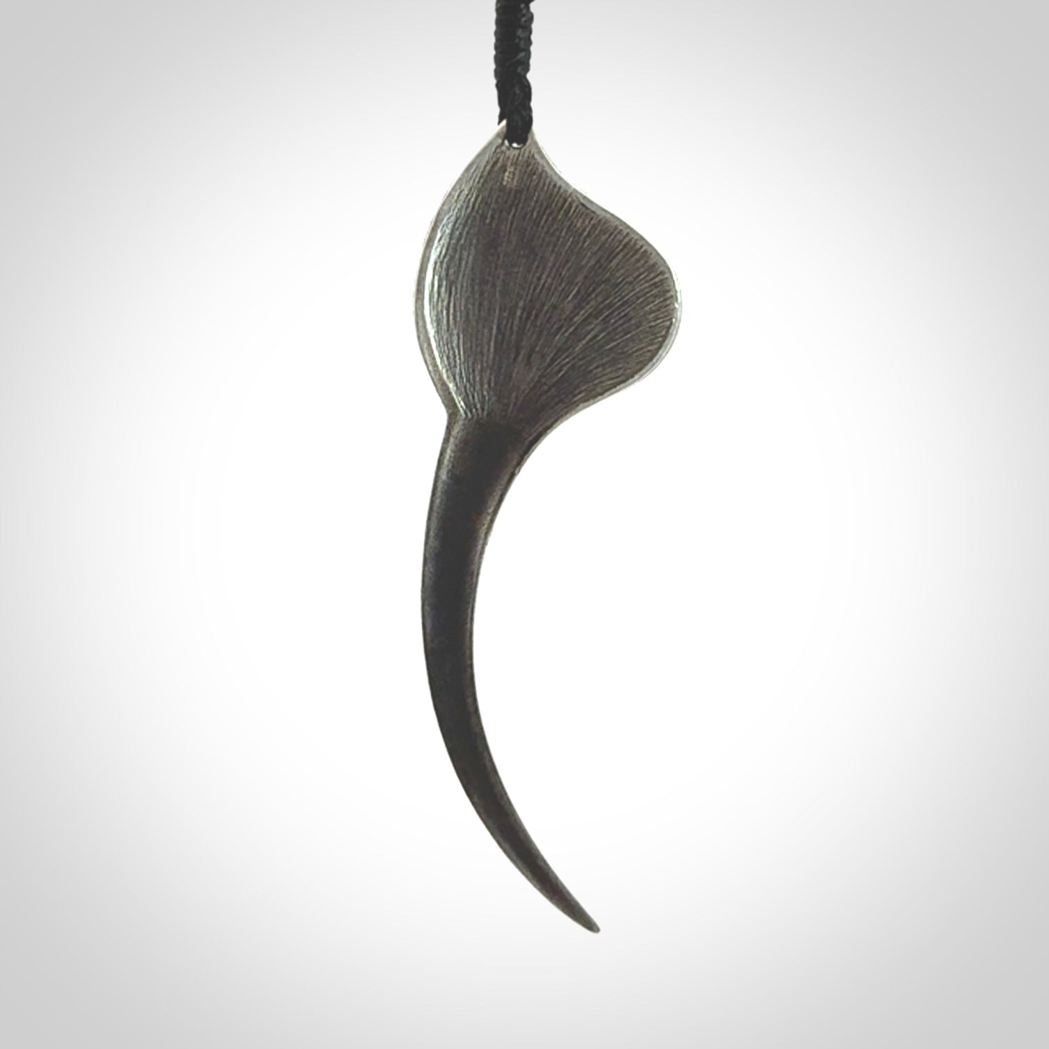 This is a hand carved Sterling Silver Huia bird pendant with Siberian Jade insert. This is a large sized necklace and is provided with an adjustable black cord.