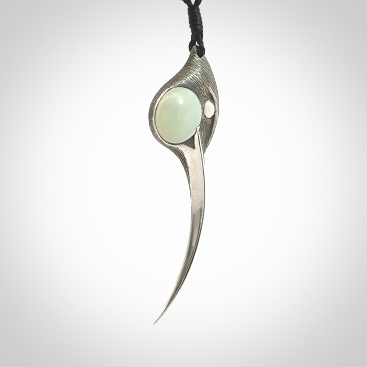 This is a hand carved Sterling Silver Huia bird pendant with Siberian Jade insert. This is a large sized necklace and is provided with an adjustable black cord.