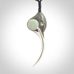 This is a hand carved Sterling Silver Huia bird pendant with Siberian Jade insert. This is a large sized necklace and is provided with an adjustable black cord.