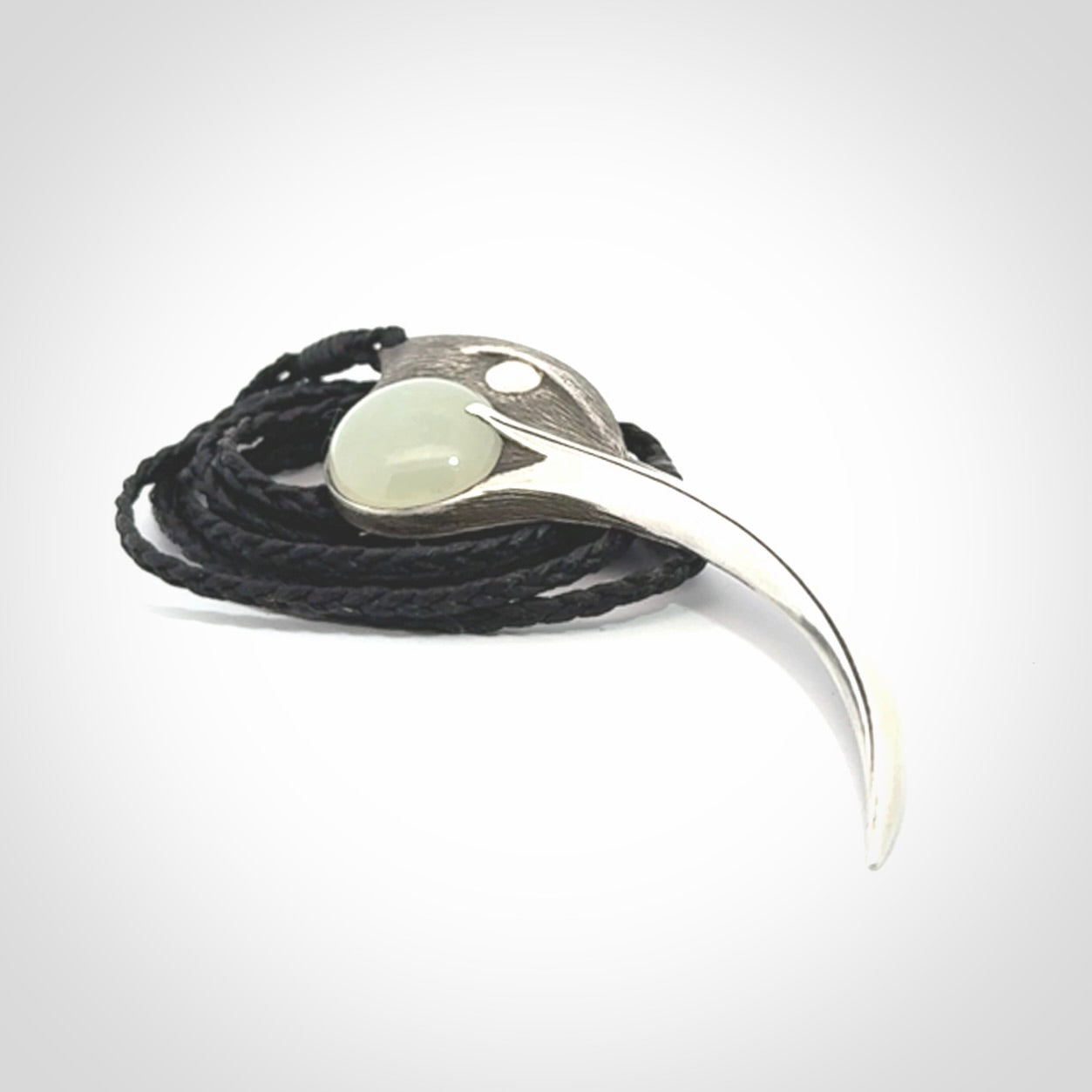 This is a hand carved Sterling Silver Huia bird pendant with Siberian Jade insert. This is a large sized necklace and is provided with an adjustable black cord.