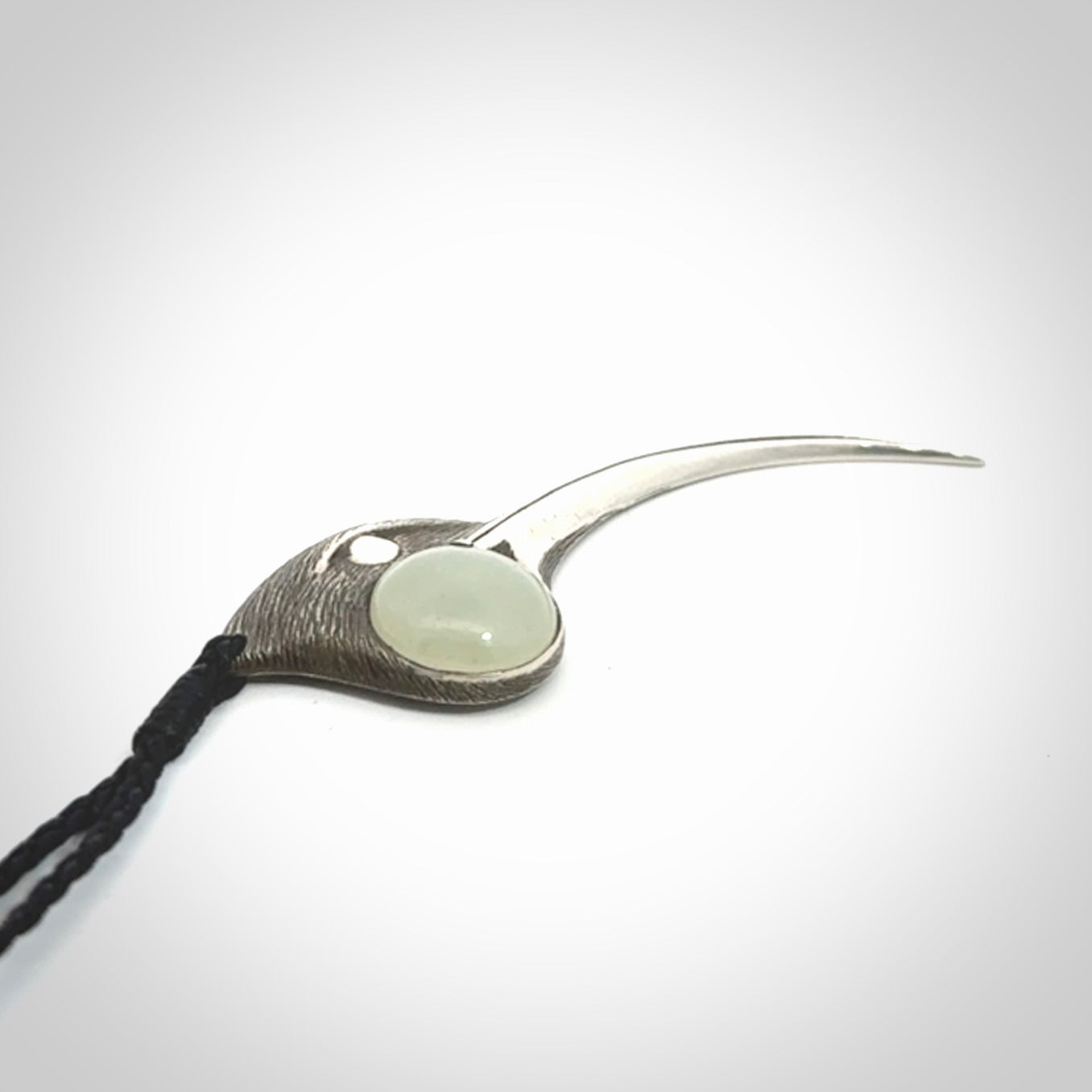 This is a hand carved Sterling Silver Huia bird pendant with Siberian Jade insert. This is a large sized necklace and is provided with an adjustable black cord.