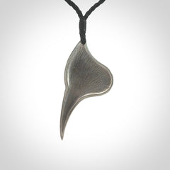 This is a hand carved Sterling Silver Huia bird pendant with New Zealand Jade insert. This is a medium sized necklace and is provided with an adjustable black cord.