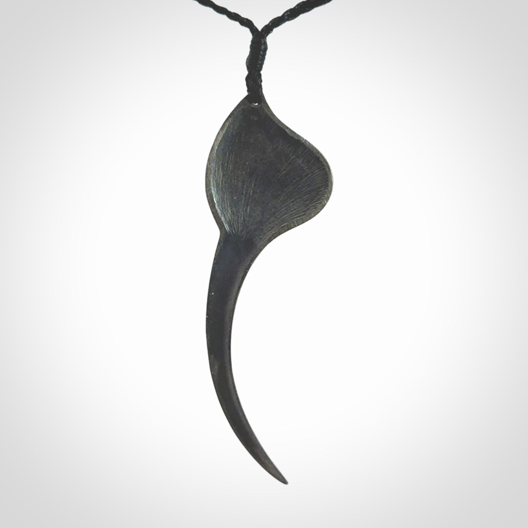 This is a hand carved Sterling Silver Huia bird pendant with New Zealand Jade insert. This is a large sized necklace and is provided with an adjustable black cord.