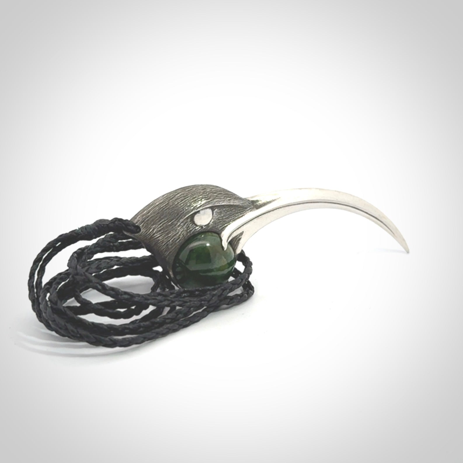 This is a hand carved Sterling Silver Huia bird pendant with New Zealand Jade insert. This is a large sized necklace and is provided with an adjustable black cord.