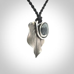 This is a hand carved Sterling Silver Kawakawa leaf pendant with New Zealand Jade insert. This is a medium sized necklace and is provided with an adjustable black cord.