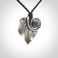 This is a hand carved Sterling Silver Kawakawa leaf pendant with New Zealand Jade insert. This is a medium sized necklace and is provided with an adjustable black cord.