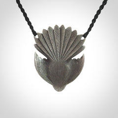 This is a hand carved Sterling Silver Fern fantail pendant with New Zealand Jade insert. This is a medium sized necklace and is provided with an adjustable black cord.