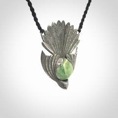 This is a hand carved Sterling Silver Fern fantail pendant with New Zealand Jade insert. This is a medium sized necklace and is provided with an adjustable black cord.