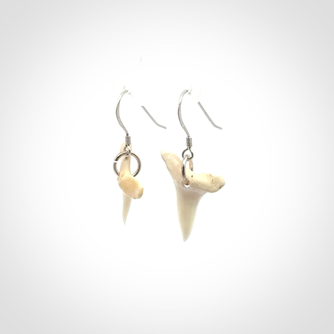 Hand carved small sized mako shark tooth earrings. Hand made shark tooth earrings. Real shark tooth art to wear. Free Shipping worldwide. Packaged in a woven kete pouch.