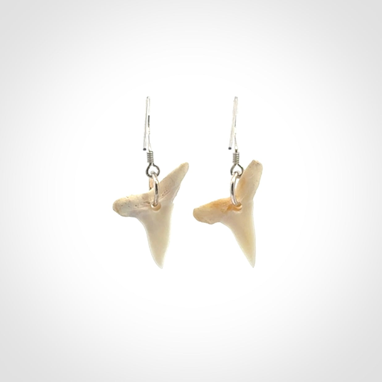 Hand carved small sized mako shark tooth earrings. Hand made shark tooth earrings. Real shark tooth art to wear. Free Shipping worldwide. Packaged in a woven kete pouch.