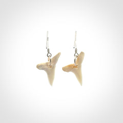 Hand carved small sized mako shark tooth earrings. Hand made shark tooth earrings. Real shark tooth art to wear. Free Shipping worldwide. Packaged in a woven kete pouch.