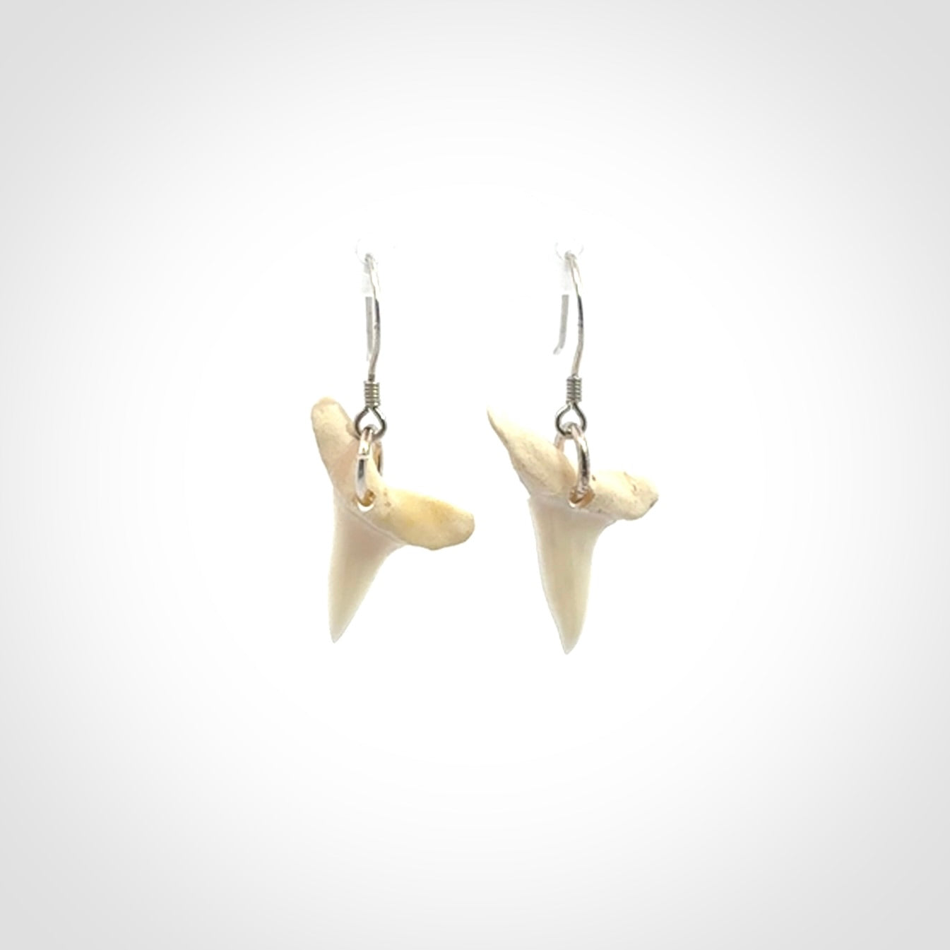 Hand carved small sized mako shark tooth earrings. Hand made shark tooth earrings. Real shark tooth art to wear. Free Shipping worldwide. Packaged in a woven kete pouch.