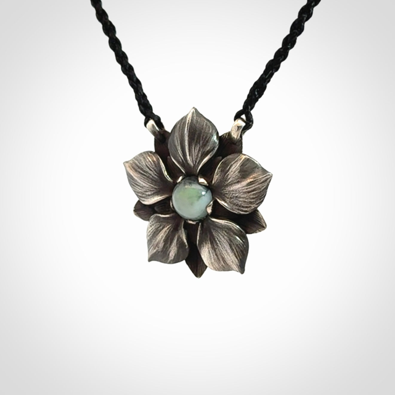Hand crafted silver manuka flower pendant with jade insert