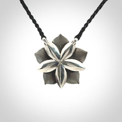 This is a hand carved Sterling Silver Manuka Flower pendant with New Zealand Jade insert. This is a medium sized necklace and is provided with an adjustable black cord.