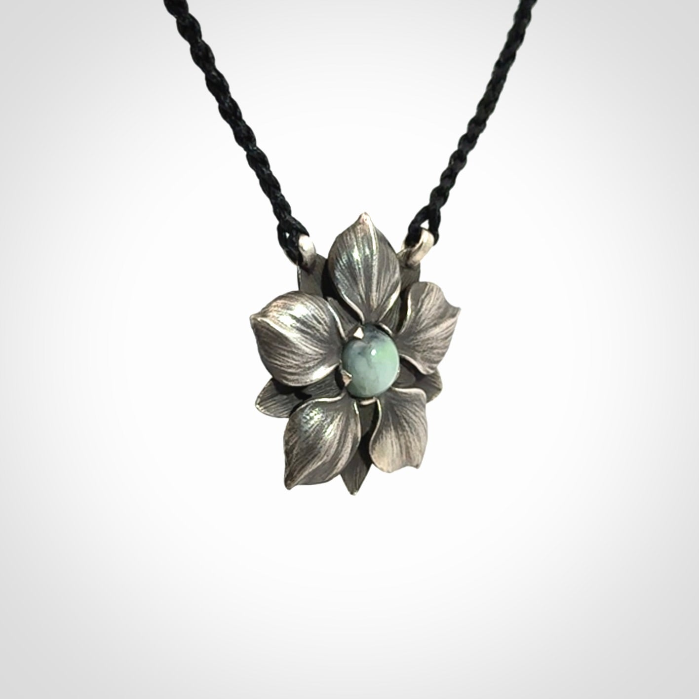 Hand crafted silver manuka flower pendant with jade insert