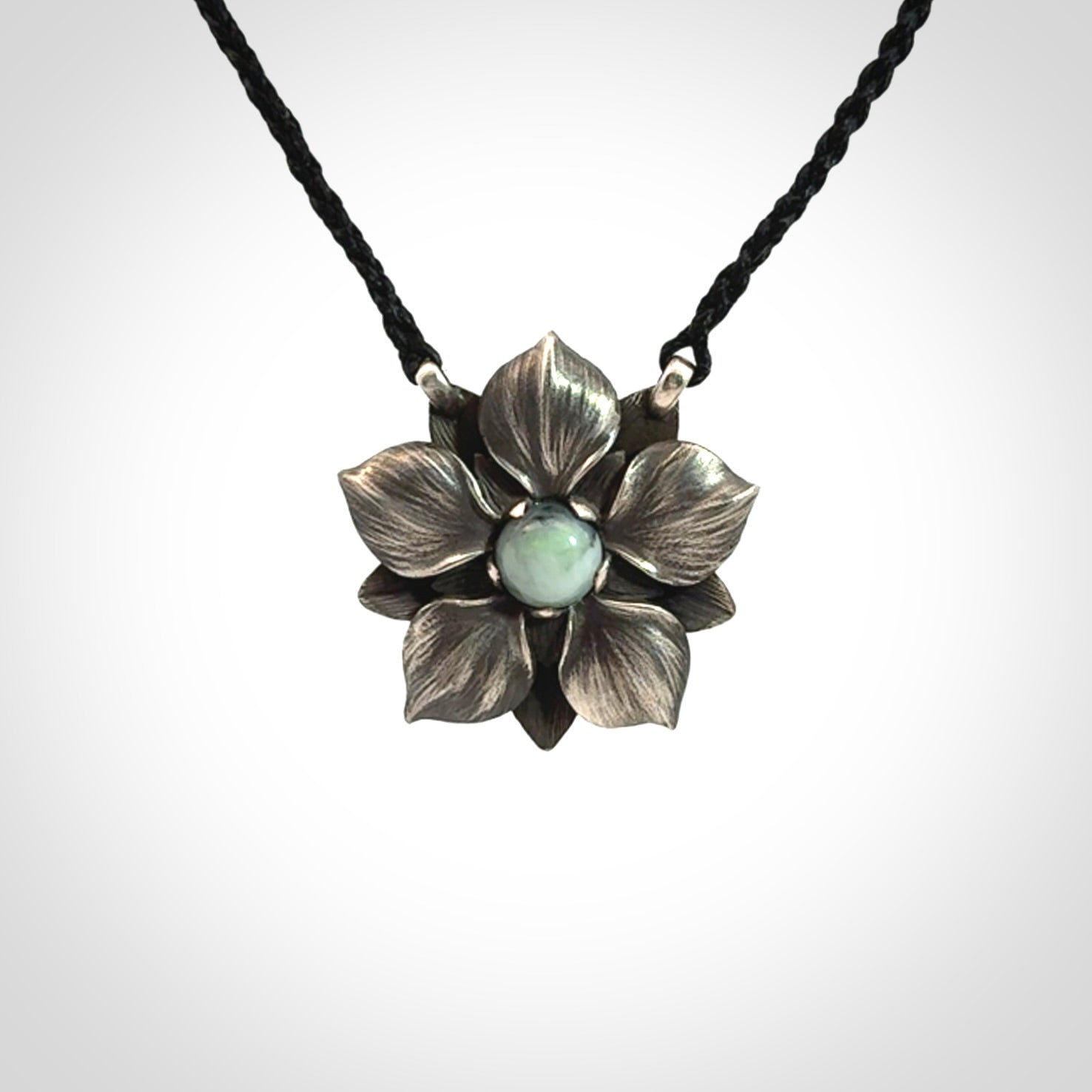 Hand crafted silver manuka flower pendant with jade insert