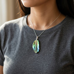 Woman wearing a paua shell and sterling silver pendant