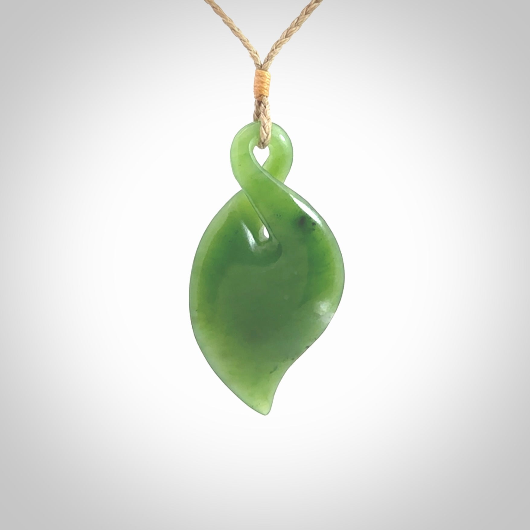 Hand carved New Zealand jade, single twist pendant. Jade twist pendant hand carved in New Zealand. Made by NZ Pacific, jade jewellery for sale online. One only hand made by Ross Crump.