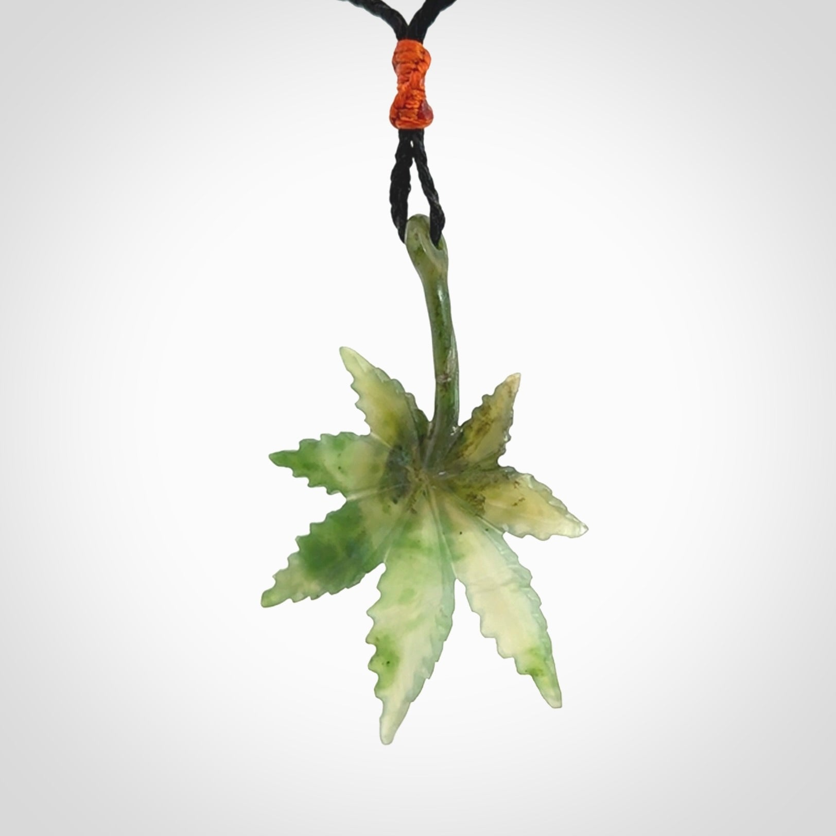 Cannabis Leaf Jade Stone pendant. Handmade jade Cannabis flower jewellery made by NZ Pacific and for sale online. Jade stone Marijuana leaf pendant for men and women. Unique art to wear from NZ Pacific. Delivered on an adjustable cord.