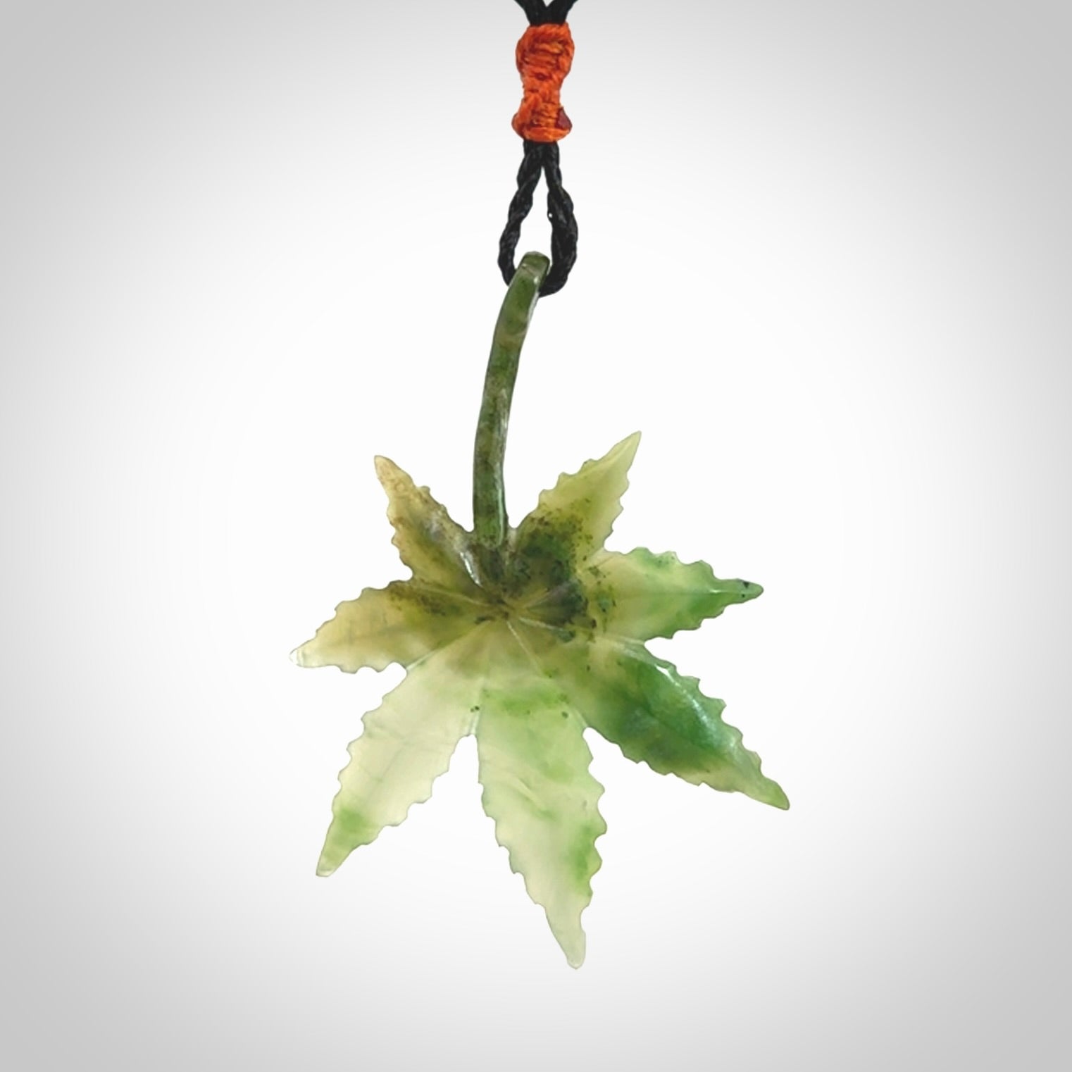 Cannabis Leaf Jade Stone pendant. Handmade jade Cannabis flower jewellery made by NZ Pacific and for sale online. Jade stone Marijuana leaf pendant for men and women. Unique art to wear from NZ Pacific. Delivered on an adjustable cord.