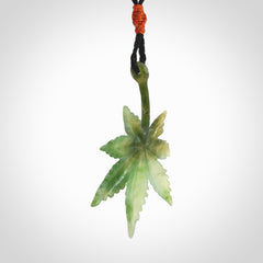 Cannabis Leaf Jade Stone pendant. Handmade jade Cannabis flower jewellery made by NZ Pacific and for sale online. Jade stone Marijuana leaf pendant for men and women. Unique art to wear from NZ Pacific. Delivered on an adjustable cord.