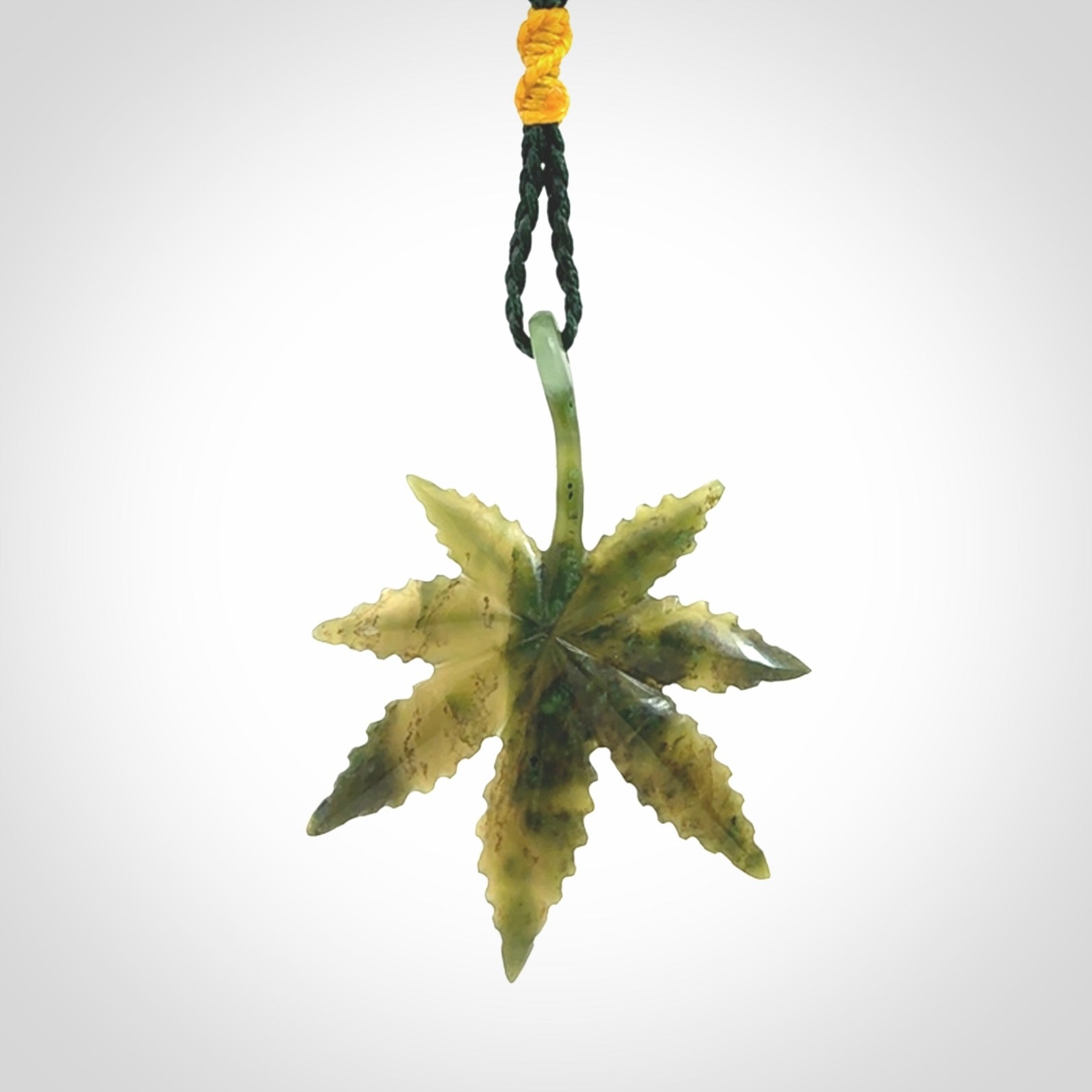 Cannabis Leaf Jade Stone pendant. Handmade jade Cannabis flower jewellery made by NZ Pacific and for sale online. Jade stone Marijuana leaf pendant for men and women. Unique art to wear from NZ Pacific. Delivered on an adjustable cord.