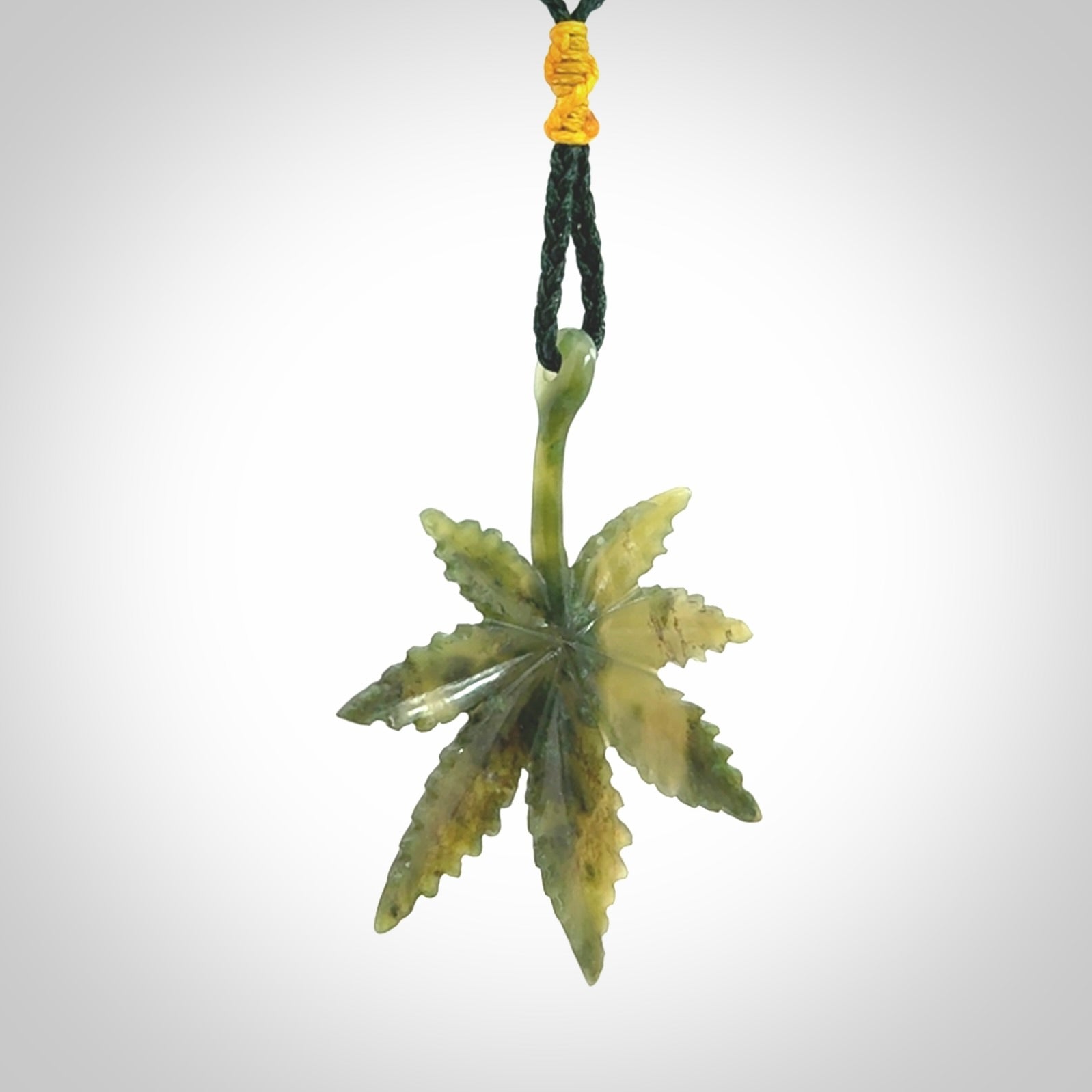 Cannabis Leaf Jade Stone pendant. Handmade jade Cannabis flower jewellery made by NZ Pacific and for sale online. Jade stone Marijuana leaf pendant for men and women. Unique art to wear from NZ Pacific. Delivered on an adjustable cord.