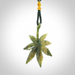 Cannabis Leaf Jade Stone pendant. Handmade jade Cannabis flower jewellery made by NZ Pacific and for sale online. Jade stone Marijuana leaf pendant for men and women. Unique art to wear from NZ Pacific. Delivered on an adjustable cord.