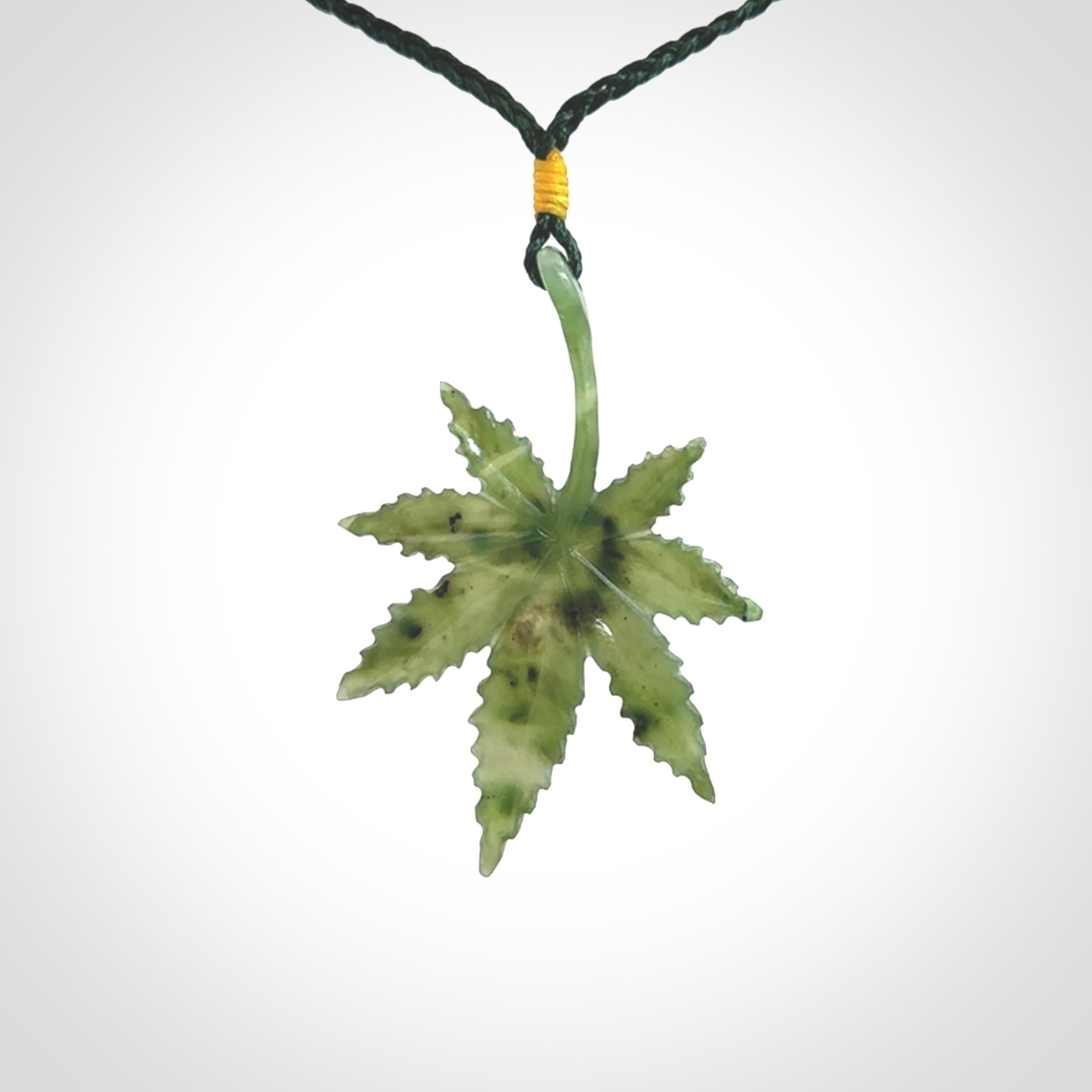 Cannabis Leaf Jade Stone pendant. Handmade jade Cannabis flower jewellery made by NZ Pacific and for sale online. Jade stone Marijuana leaf pendant for men and women. Unique art to wear from NZ Pacific. Delivered on an adjustable cord.