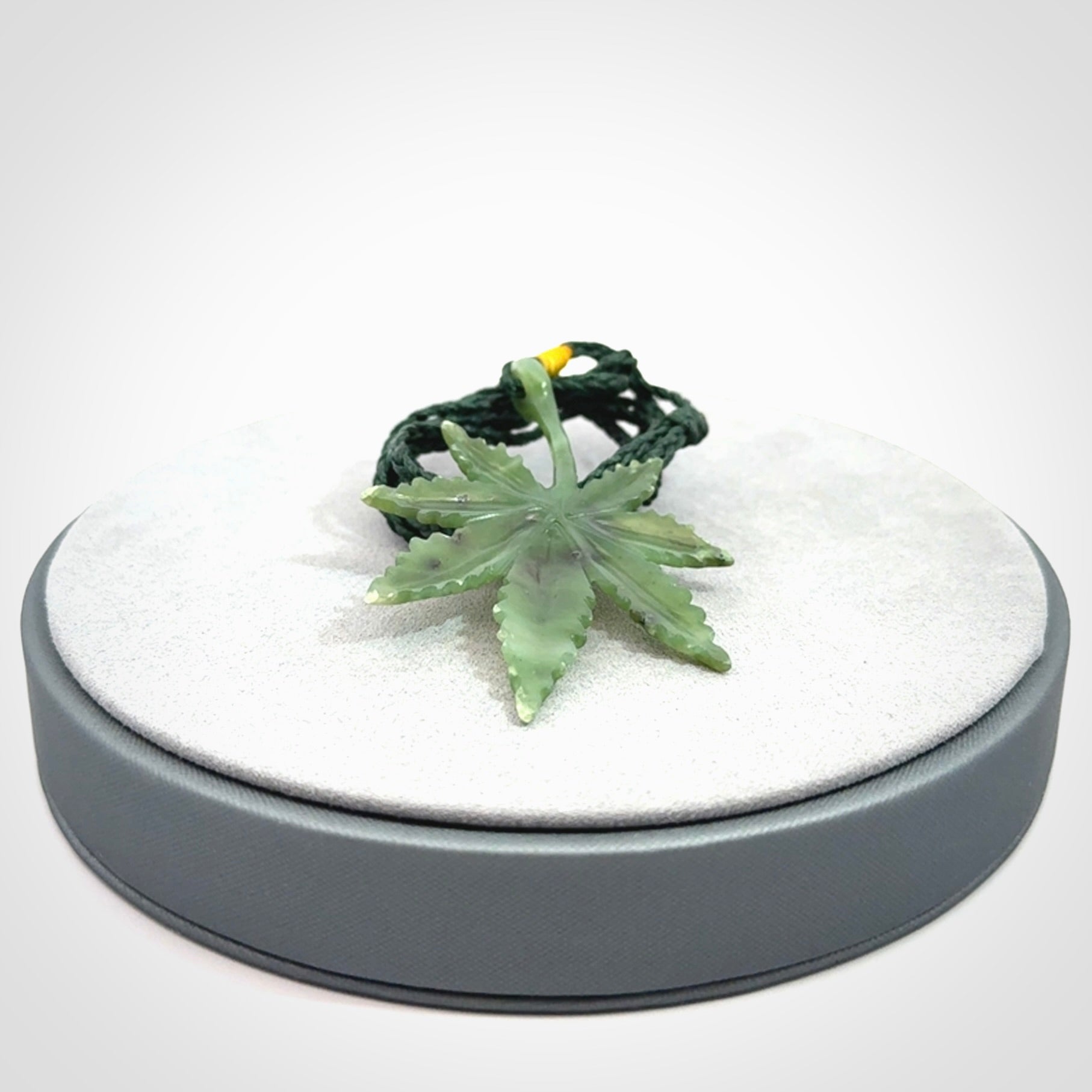Cannabis Leaf Jade Stone pendant. Handmade jade Cannabis flower jewellery made by NZ Pacific and for sale online. Jade stone Marijuana leaf pendant for men and women. Unique art to wear from NZ Pacific. Delivered on an adjustable cord.