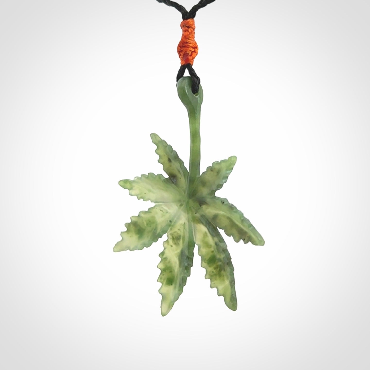 Cannabis Leaf Jade Stone pendant. Handmade jade Cannabis flower jewellery made by NZ Pacific and for sale online. Jade stone Marijuana leaf pendant for men and women. Unique art to wear from NZ Pacific. Delivered on an adjustable cord.