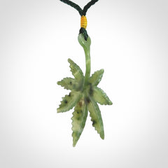 Cannabis Leaf Jade Stone pendant. Handmade jade Cannabis flower jewellery made by NZ Pacific and for sale online. Jade stone Marijuana leaf pendant for men and women. Unique art to wear from NZ Pacific. Delivered on an adjustable cord.