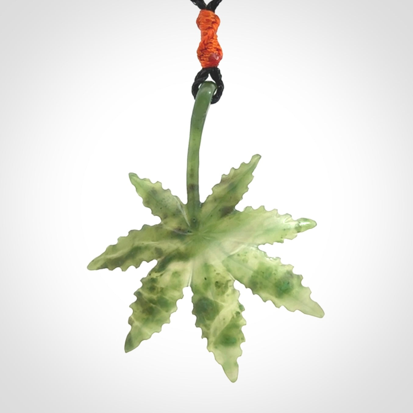 Cannabis Leaf Jade Stone pendant. Handmade jade Cannabis flower jewellery made by NZ Pacific and for sale online. Jade stone Marijuana leaf pendant for men and women. Unique art to wear from NZ Pacific. Delivered on an adjustable cord.