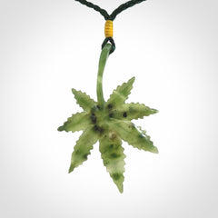Cannabis Leaf Jade Stone pendant. Handmade jade Cannabis flower jewellery made by NZ Pacific and for sale online. Jade stone Marijuana leaf pendant for men and women. Unique art to wear from NZ Pacific. Delivered on an adjustable cord.