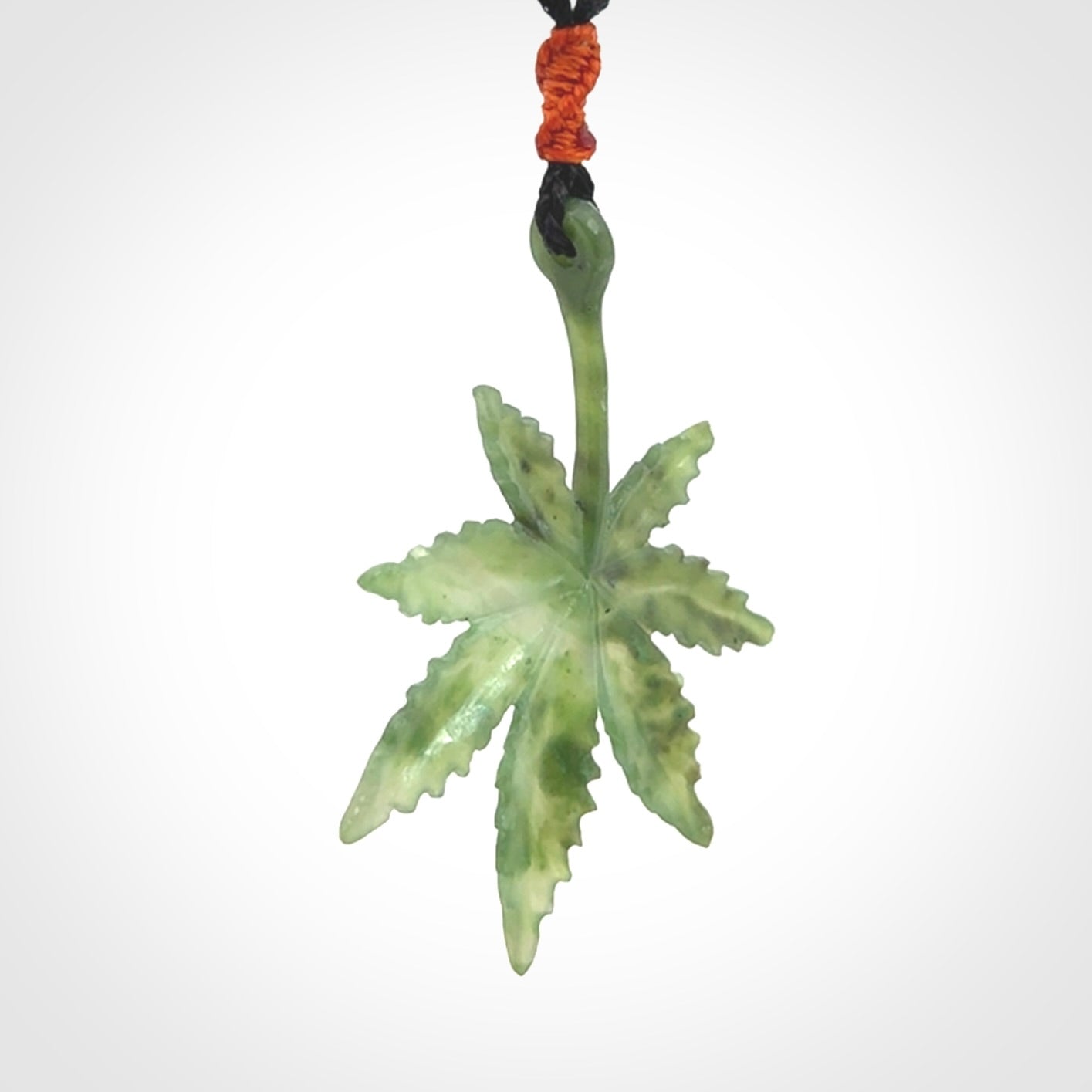 Cannabis Leaf Jade Stone pendant. Handmade jade Cannabis flower jewellery made by NZ Pacific and for sale online. Jade stone Marijuana leaf pendant for men and women. Unique art to wear from NZ Pacific. Delivered on an adjustable cord.