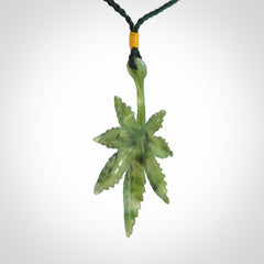 Cannabis Leaf Jade Stone pendant. Handmade jade Cannabis flower jewellery made by NZ Pacific and for sale online. Jade stone Marijuana leaf pendant for men and women. Unique art to wear from NZ Pacific. Delivered on an adjustable cord.